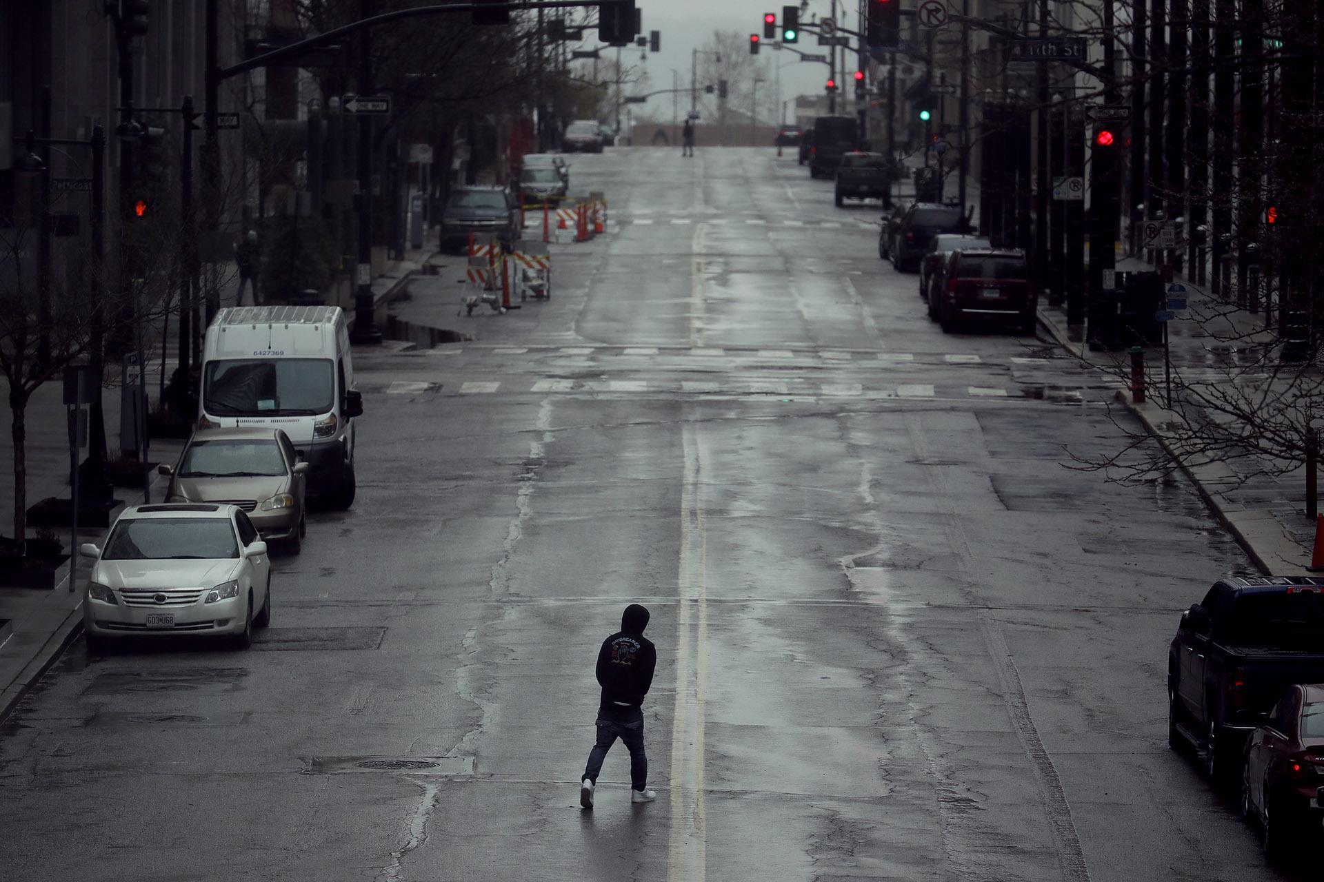 In this April 3, 2020, file photo a man crosses an empty street in downtown Kansas City, Missouri. (AP Photo / Charlie Riedel, File)