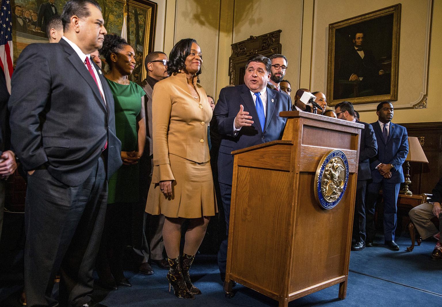 Gov. J.B. Pritzker gives his opening remarks along with state Sen. Kimberly Lightford, D-Maywood, left, on Senate Bill 1, a bill sponsored by Lightford to raise the state’s minimum wage to 5 an hour by 2025, after it passed the Illinois Senate during a press conference in the governor’s office at the Illinois state Capitol, Thursday, Feb. 7, 2019. (Justin L. Fowler / The State Journal-Register via AP)