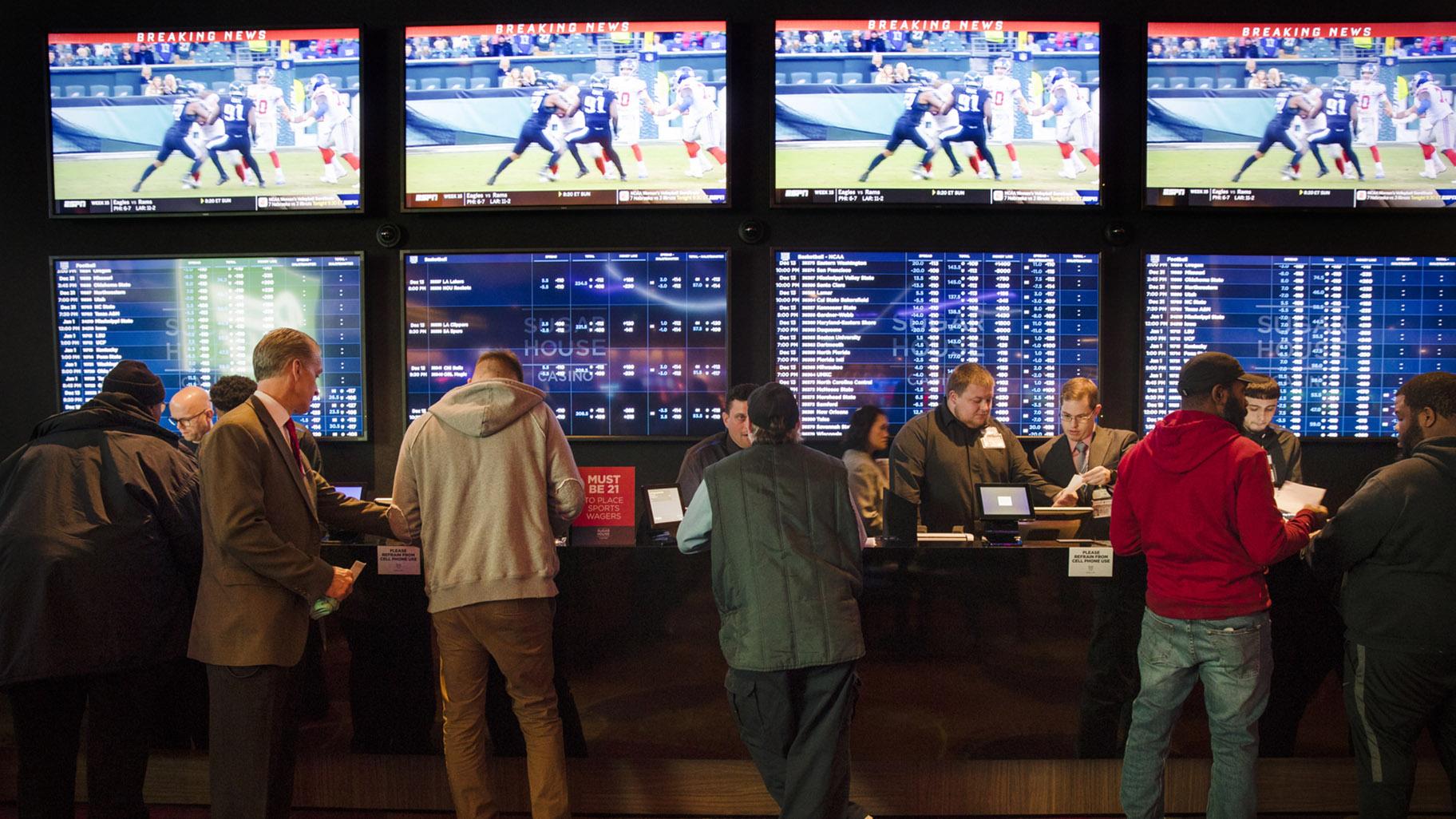In this Thursday, Dec. 13, 2018, file photo, gamblers place bets in the temporary sports betting area at the SugarHouse Casino in Philadelphia. (AP Photo / Matt Rourke, File)