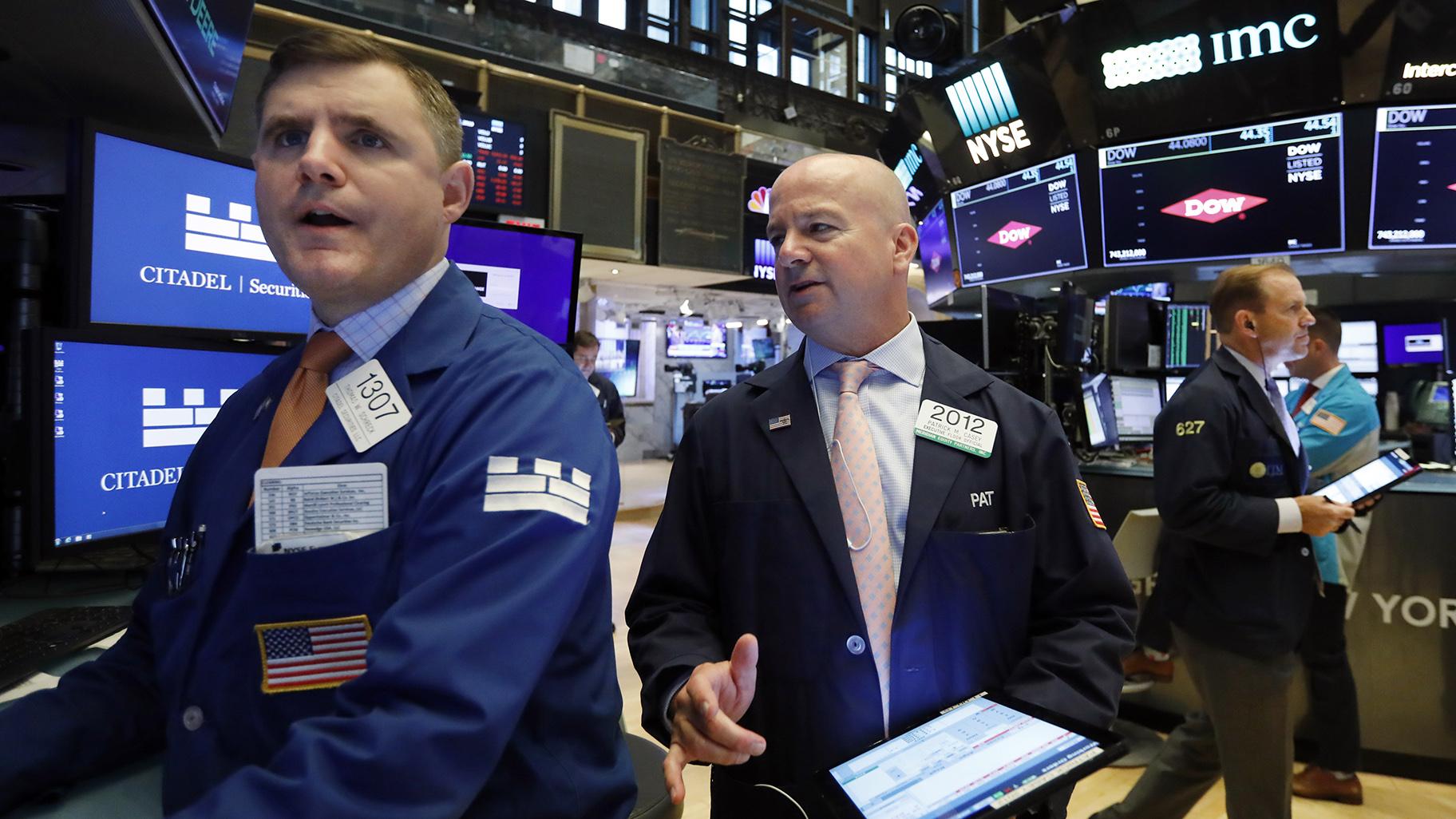 Specialist Thomas Schreck, left, and trader Patrick Casey, center, work on the floor of the New York Stock Exchange, Thursday, Aug. 15, 2019. Stocks are rising on Wall Street early Thursday on indications American consumers continue to spend and embrace online shopping. (AP Photo / Richard Drew)