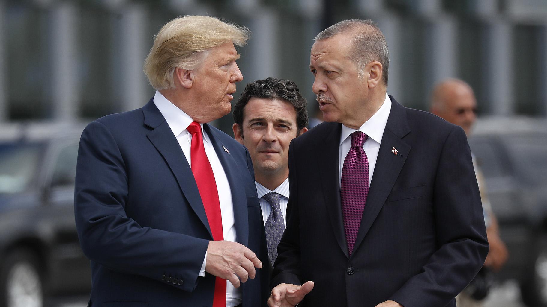 In this Wednesday, July 11, 2018, file photo, President Donald Trump, left, talks with Turkey's President Recep Tayyip Erdogan, as they arrive together for a family photo at a summit of heads of state and government at NATO headquarters in Brussels. (AP Photo / Pablo Martinez Monsivais, File)