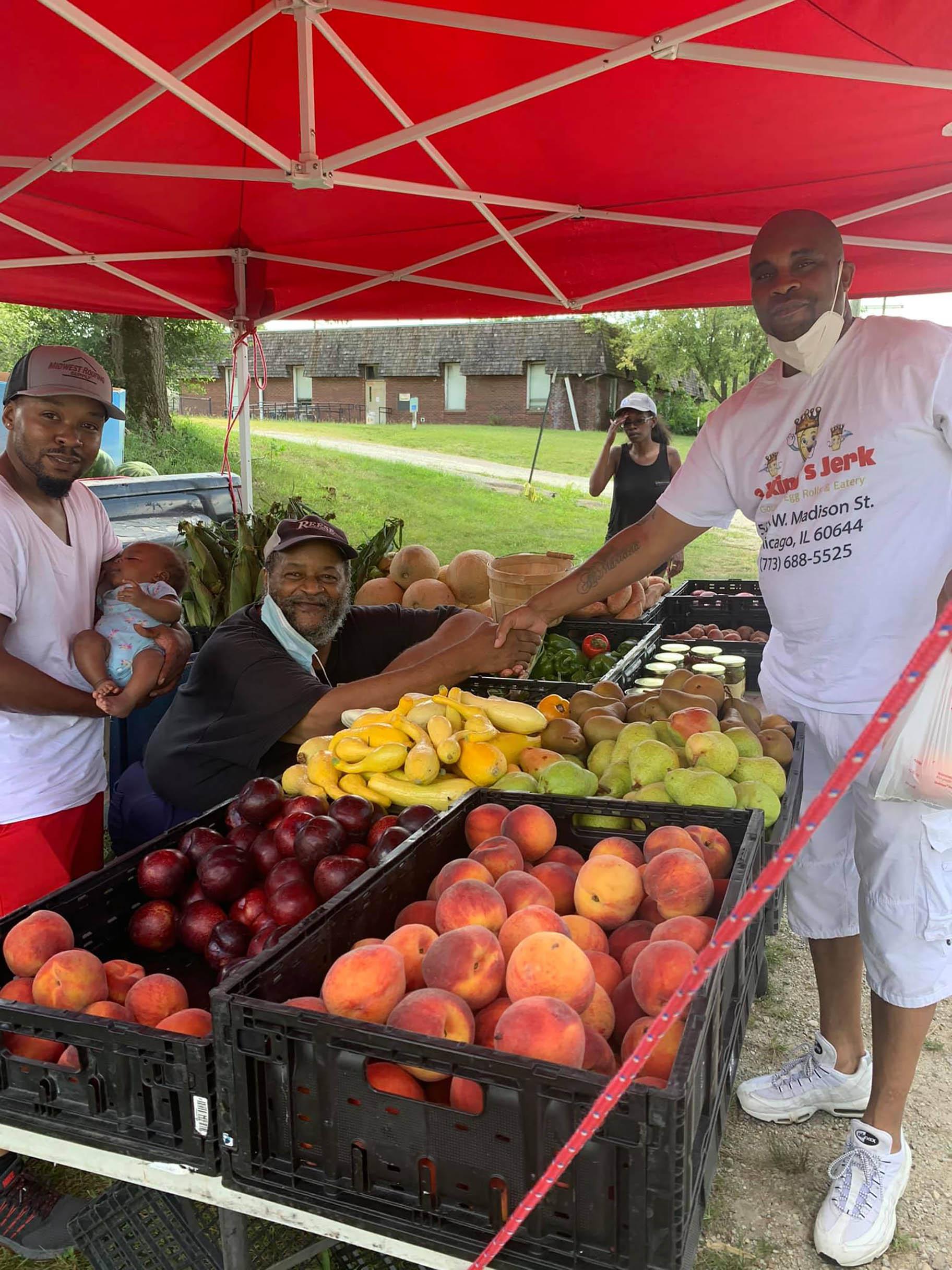 Albert Person meets with a farming family to pick up fresh produce in Kankakee, IL. (Courtesy: Albert Person)