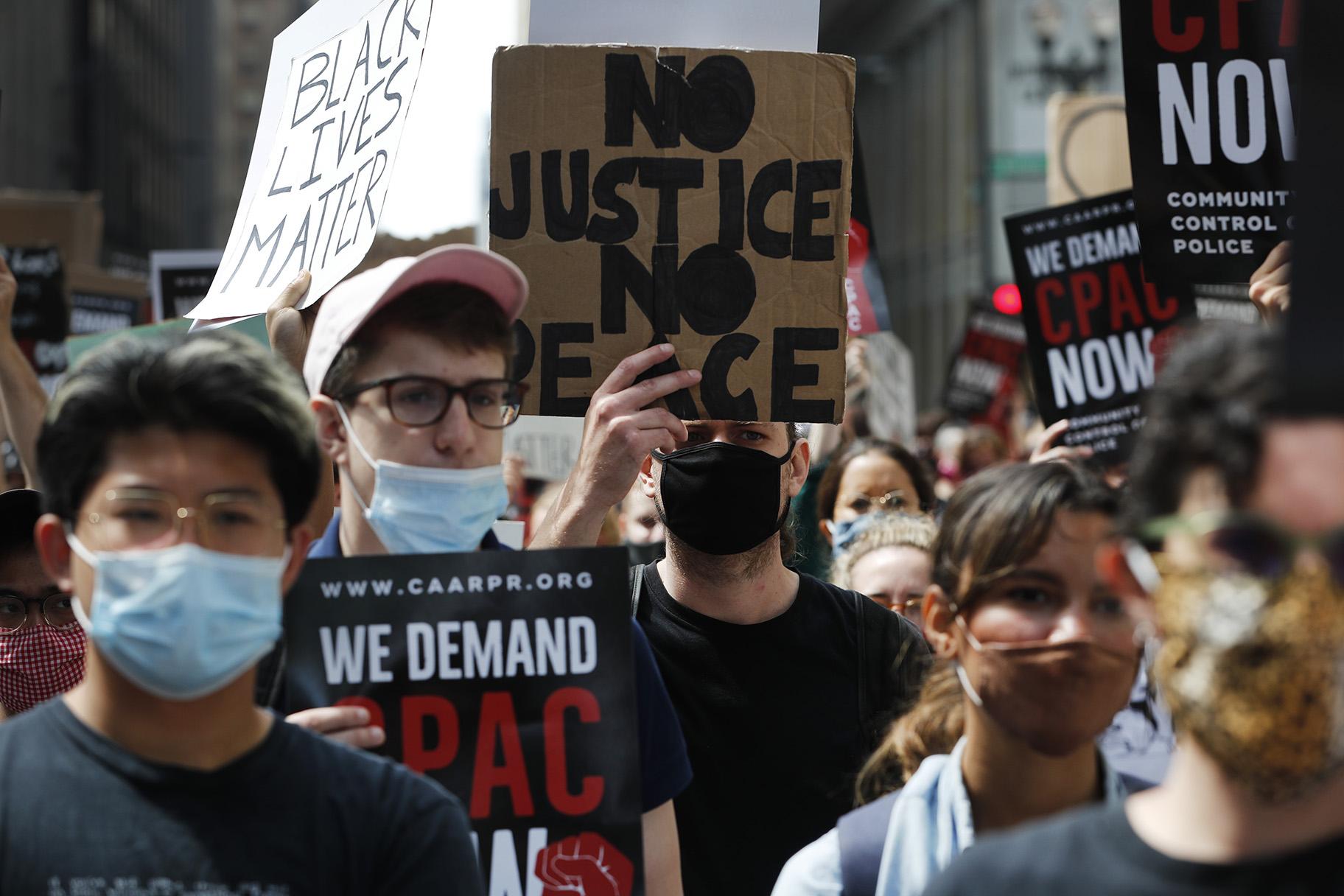 Protesters march around Chicago’s City Hall, Wednesday, June 17, 2020, demanding that Mayor Lori Lightfoot enact the ordinance for an all-elected Civilian Police Accountability Council, CPAC. (AP Photo / Charles Rex Arbogast)