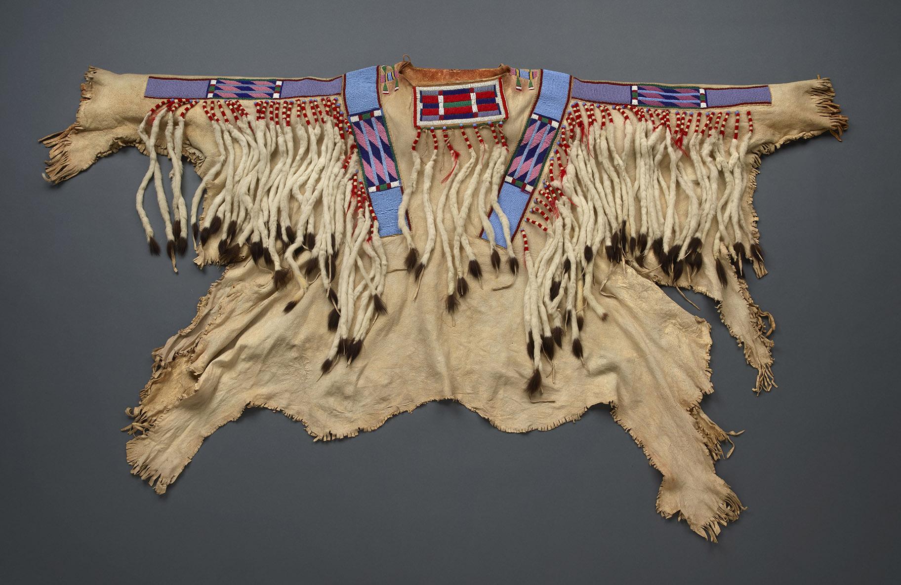 A baleiíttaashtee, or celebration shirt, made of buckskin, ermine (weasel) tails and Apsáalooke beadwork (John Weinstein / Field Museum)