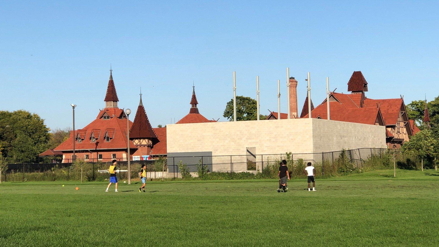The cinderblock shell of an illegal building in Humboldt Park, obscuring the landmarked Receptory and Stable building, will be demolished. (Patty Wetli / WTTW News)