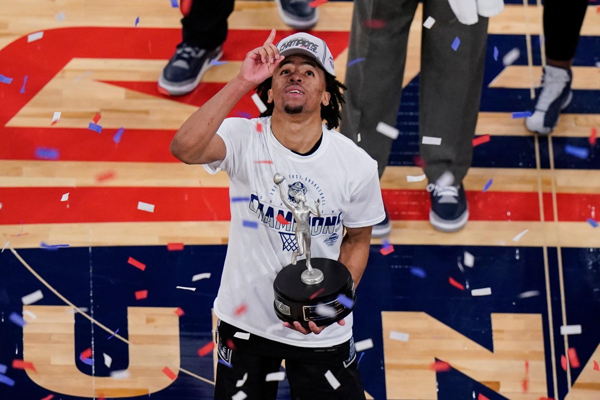 Georgetown’s Dante Harris celebrates while holding the Most Outstanding Player trophy after an NCAA college basketball game against Creighton in the championship of the Big East Conference tournament Saturday, March 13, 2021, in New York. (AP Photo / Frank Franklin II)