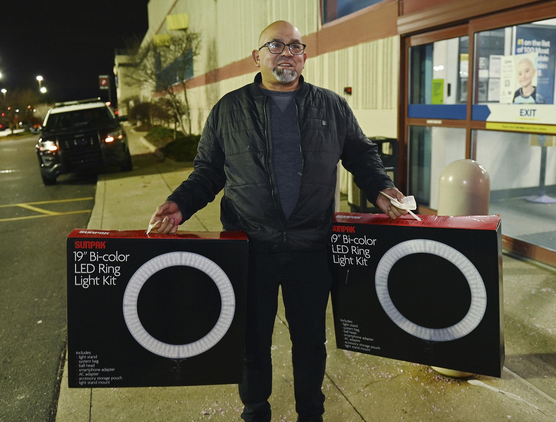 Daniel Ramon, 55, of Livonia, talks about his purchase of led lights for his daughters outside the Best Buy store in Novi, Mich., on Friday, Nov. 26, 2021. (Clarence Tabb, Jr. / Detroit News via AP)
