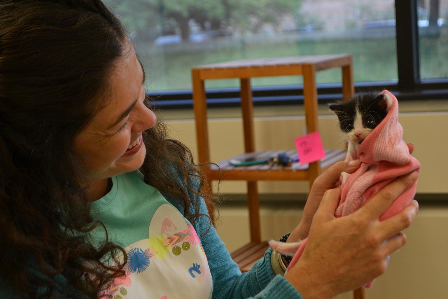 Jenny Schlueter of Chicago Animal Care and Control holds Juan, a 4-week-old kitten who arrived at the shelter last month. (Alex Ruppenthal / Chicago Tonight)