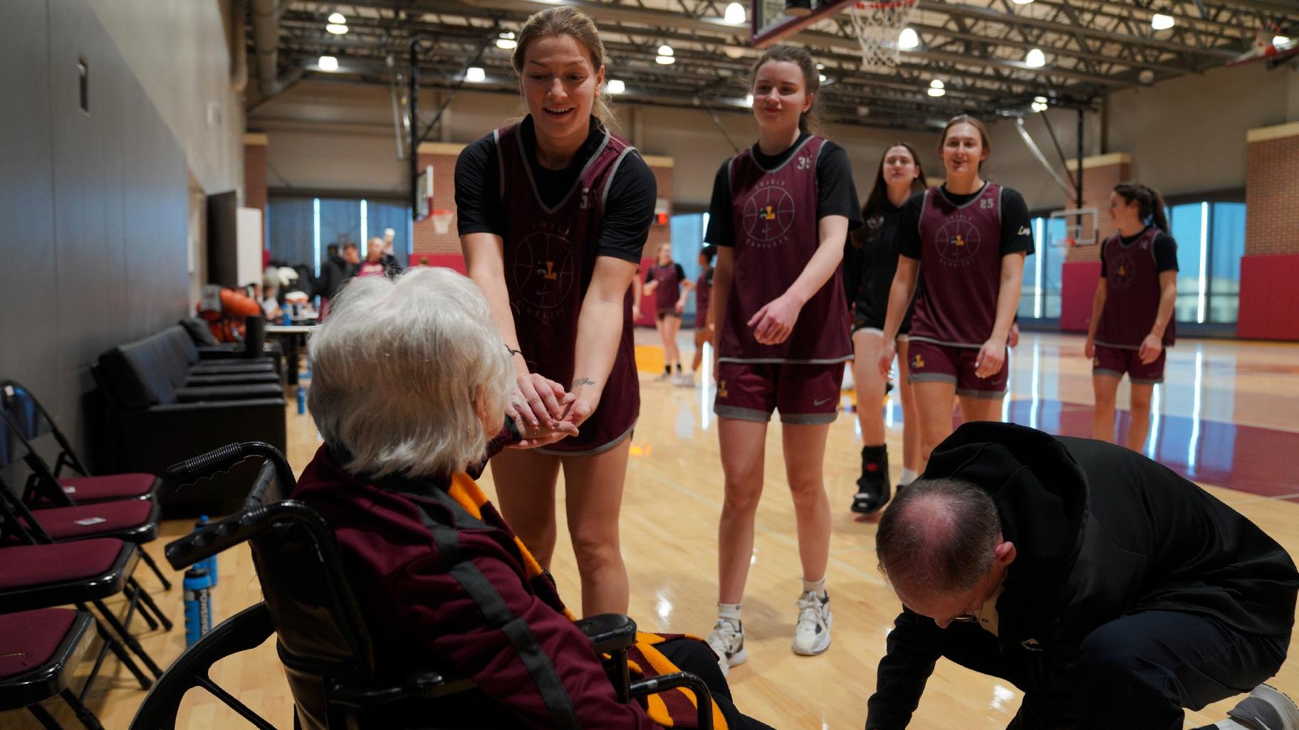Loyola University women's basketball players greet Sister Jean Dolores Schmidt with a handshake after practice on Monday, Jan. 23, 2023, in Chicago. (AP Photo / Jessie Wardarski)