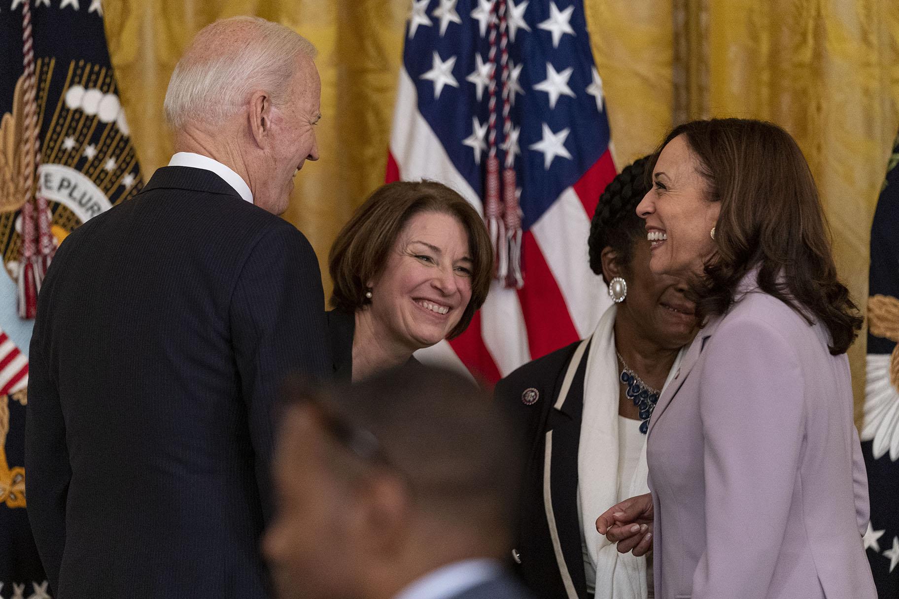 President Joe Biden, Sen. Amy Klobuchar, D-Minn., center, and Vice President Kamala Harris, right, share a laugh after the president signed H.R. 1652, the VOCA Fix to Sustain the Crime Victims Fund Act of 2021, in the East Room of the White House in Washington, Thursday, July 22, 2021. (AP Photo / Andrew Harnik)