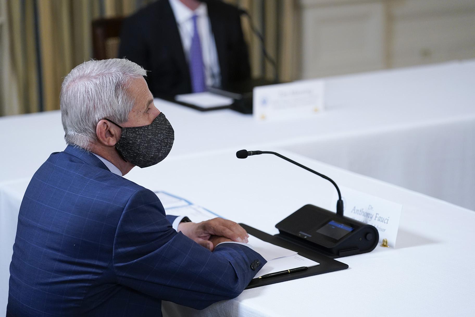 Dr. Anthony Fauci, director of the National Institute of Allergy and Infectious Diseases, listens as President Joe Biden receives a briefing in the State Dining Room of the White House in Washington, Tuesday, Aug. 10, 2021, on how the COVID-19 pandemic is impacting hurricane preparedness. (AP Photo / Susan Walsh)