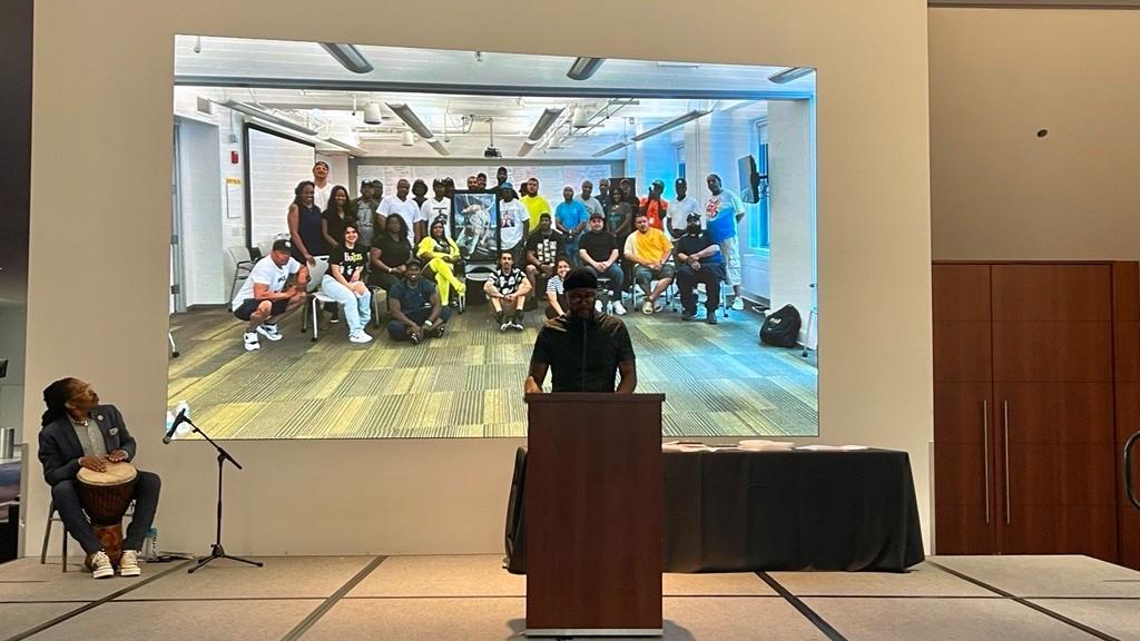 Billy Deal, field manager at Metropolitan Peace Initiatives, speaks at a Metropolitan Peace Academy graduation. The training program aims to professionalize the field of street outreach. (Credit: Metropolitan Peace Initiatives)