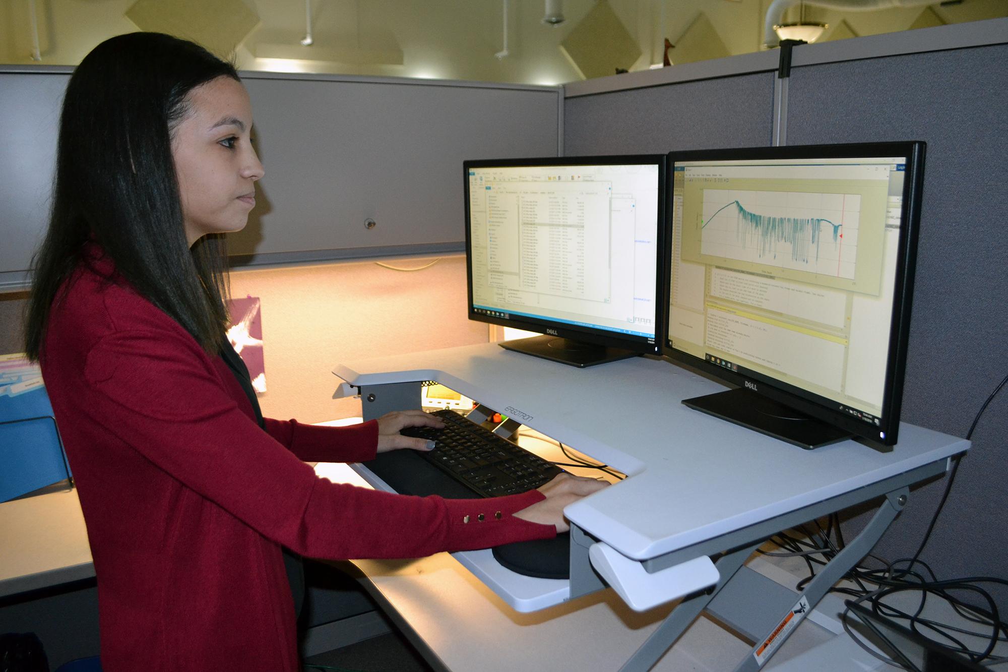 Lisa Lauderdale, a postdoctoral fellow in the Chicago Zoological Society's Animal Welfare Research department, analyzes data from bio-logging sensors attached to dolphins at Brookfield Zoo. (Alex Ruppenthal / Chicago Tonight)