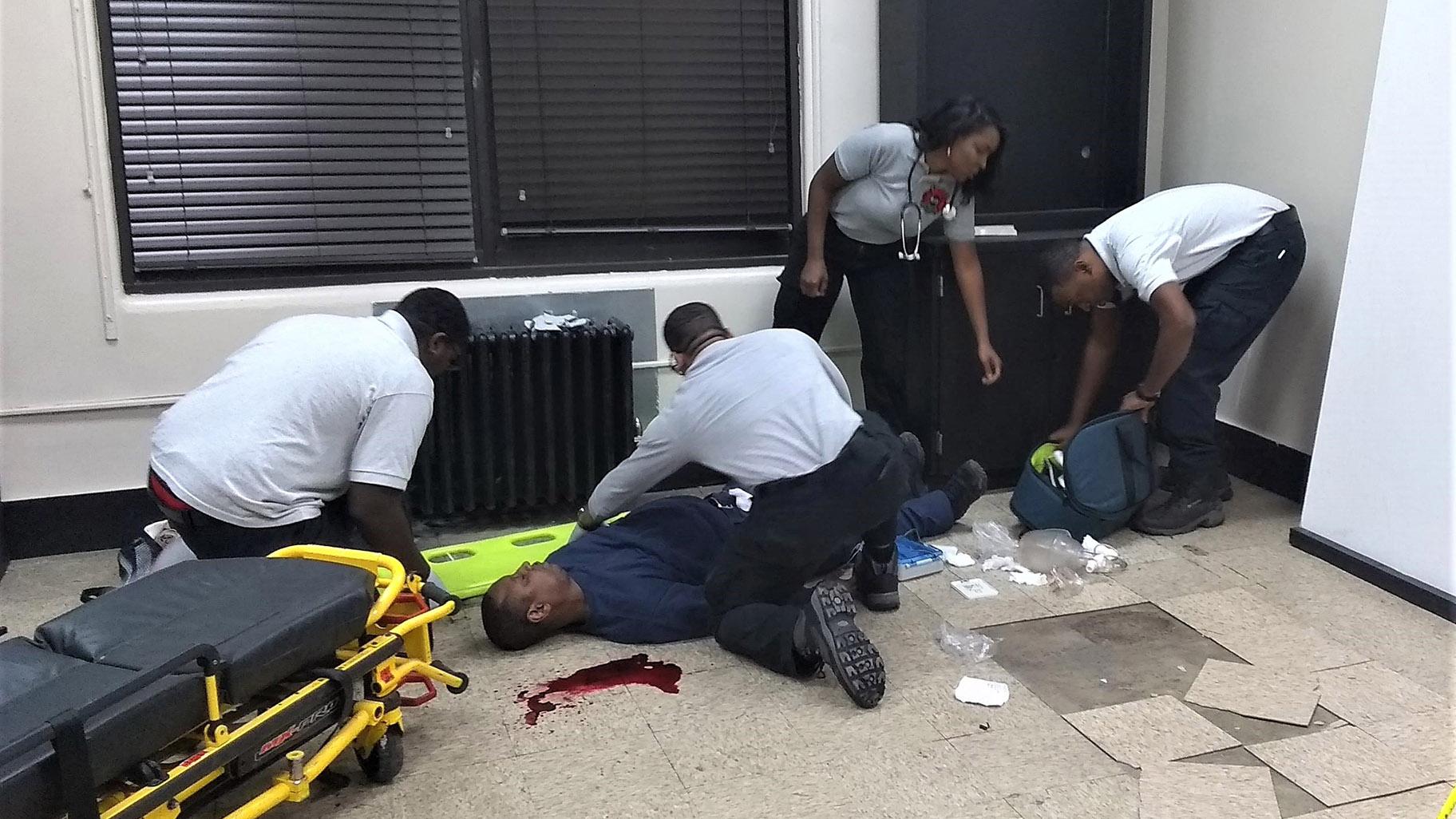 Black Fire Brigade EMT students participate in a gunshot scenario. (Matthew Carnero Macias / WTTW News)