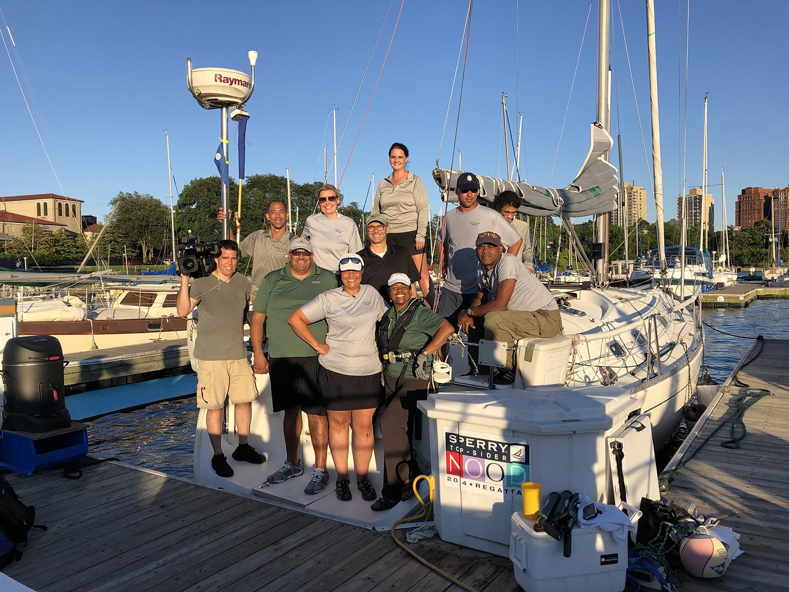 Producer Jay Shefsky and cameraman Felix Mendez pose with the crew of Mise en Place at Jackson Park Harbor. 
