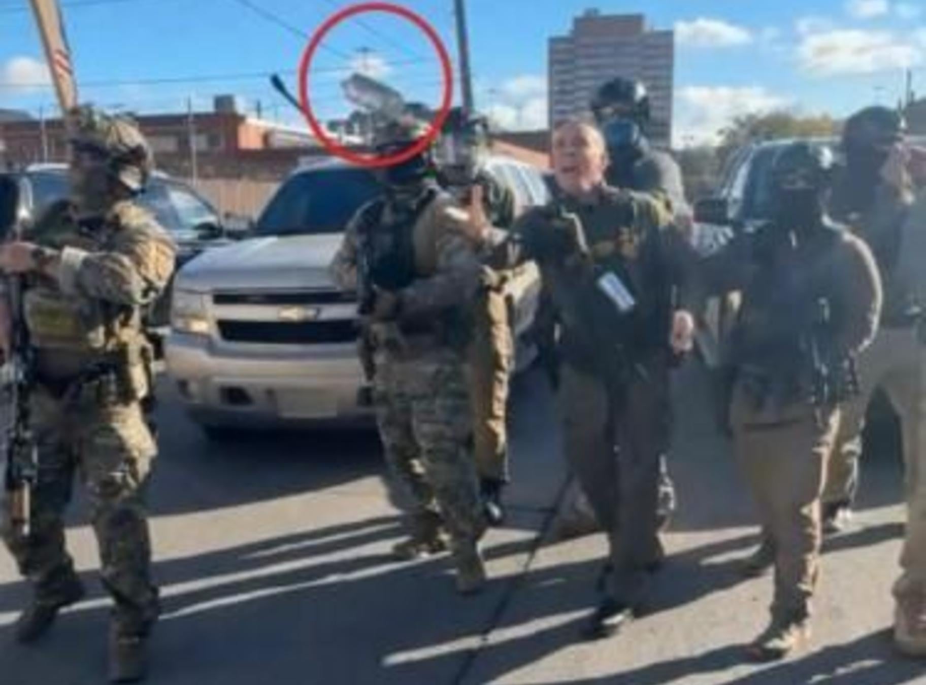 An image taken from a video entered as evidence in the court case, showing Border Patrol chief Gregory Bovino firing tear gas, circled in red by lawyers for the Chicago Headline Club, at a crowd of protesters. (Provided)