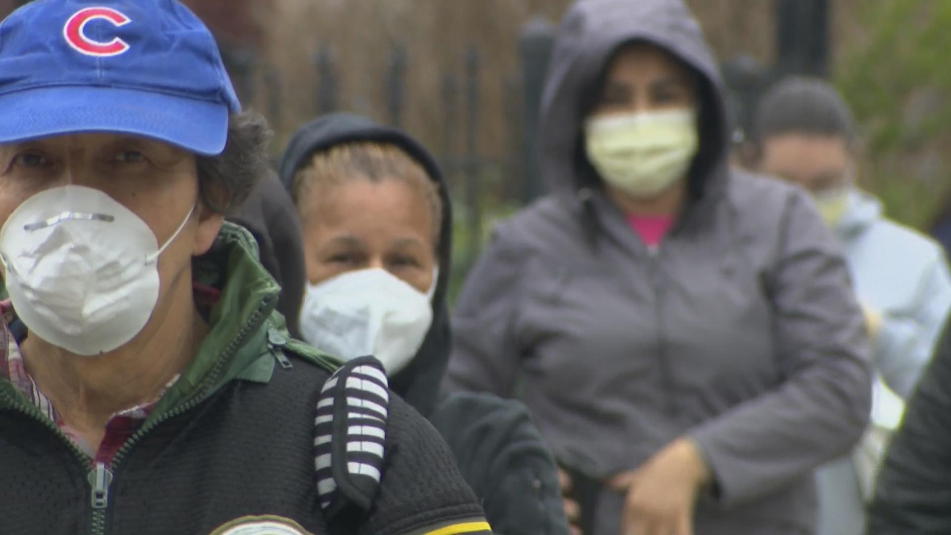 People line up for a food drive in Brighton Park in April 2020. (WTTW News)