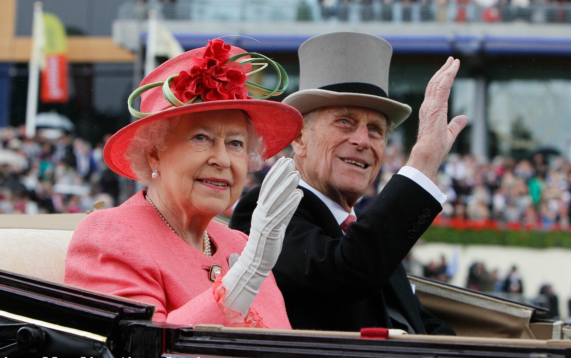 In this Thursday June, 16, 2011 file photo Britain’s Queen Elizabeth II with Prince Philip arrive by horse drawn carriage in the parade ring on the third day, traditionally known as Ladies Day, of the Royal Ascot horse race meeting at Ascot, England. (AP Photo/Alastair Grant, File)
