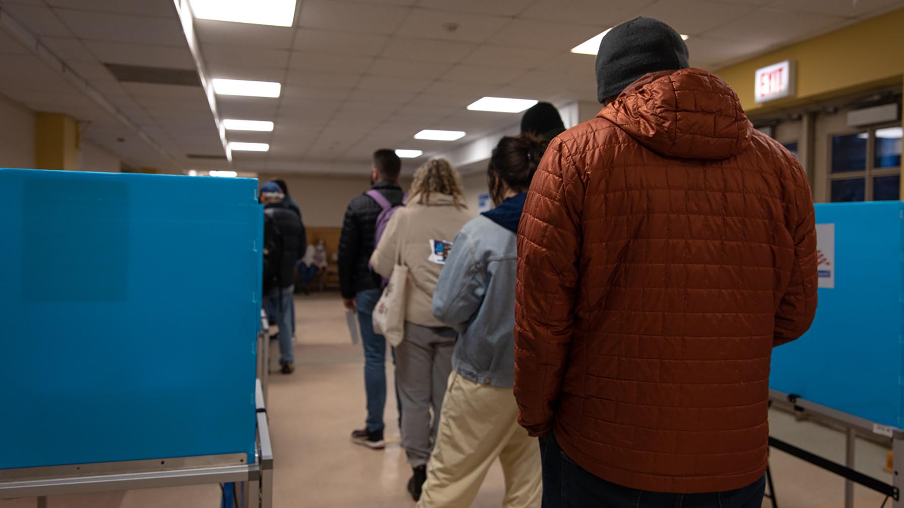 Registered voters in the 48th Ward line up inside the Broadway Armory Park polling station in anticipation to cast their ballots on Feb. 28, 2023. (Michael Izquierdo / WTTW News)