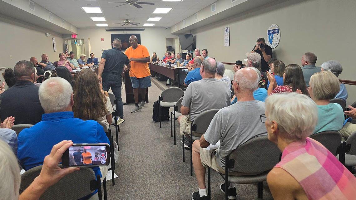 Nearly 70 people packed a Clinton County Board meeting Aug. 18, 2025, night to oppose a Proud Boys ad on a billboard near Central Community High School. (Molly Parker / Capitol News Illinois)