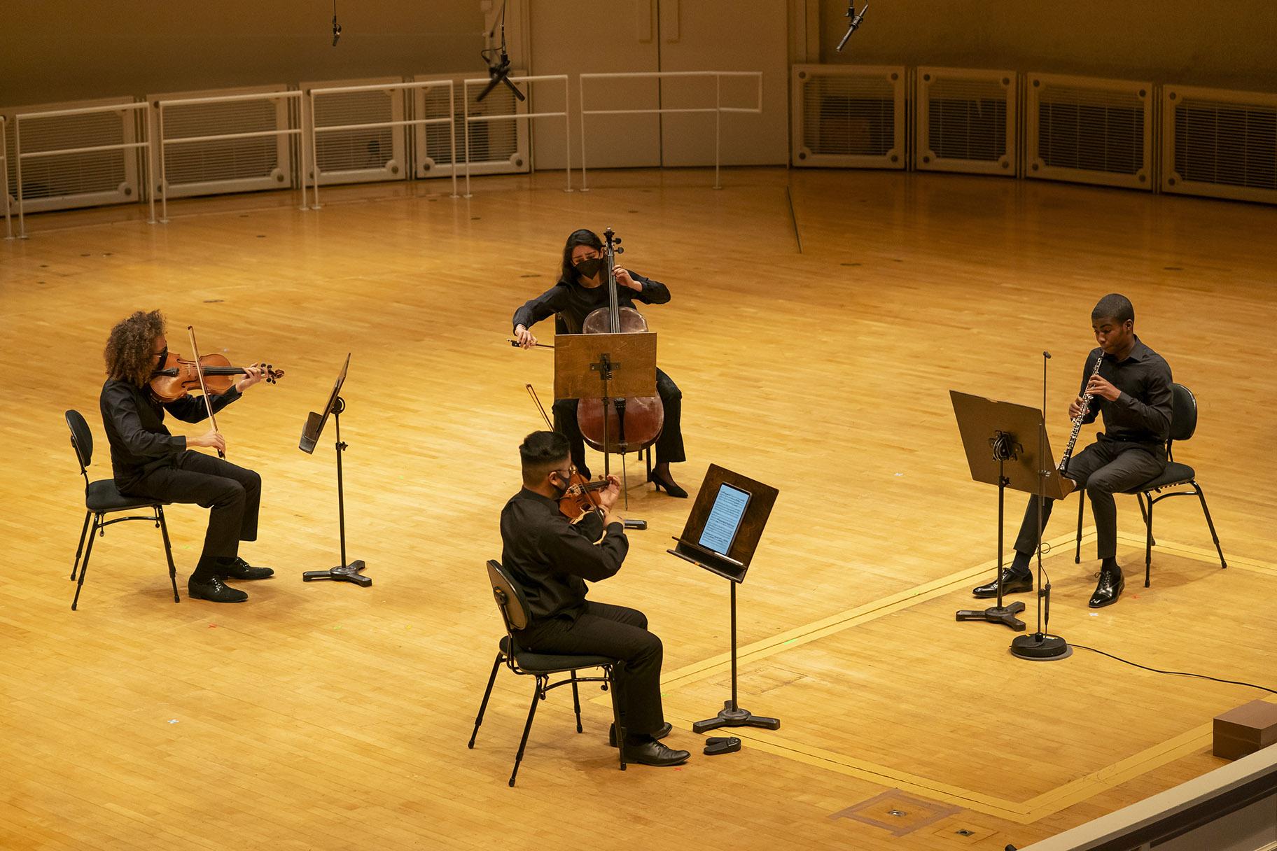 Clockwise, from left: Civic Orchestra musician and CMPI mentor Brent Taghap, Civic Orchestra alum and CMPI mentor Seth Pae, Civic Orchestra musician and CMPI mentor Najette Abouelhadi, CMPI fellow Zachary Allen. (Credit: Todd Rosenberg)