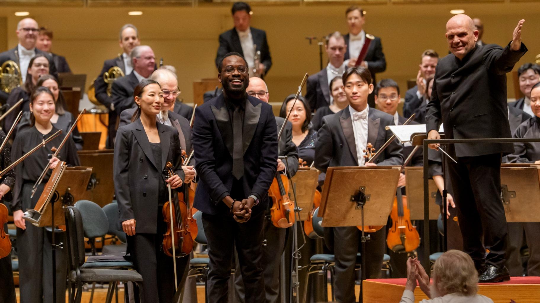 Composer Joel Thompson acknowledges audience applause and standing ovations following the Chicago Symphony Orchestra’s first performance of his piece “To See the Sky.” (Todd Rosenberg Photography)