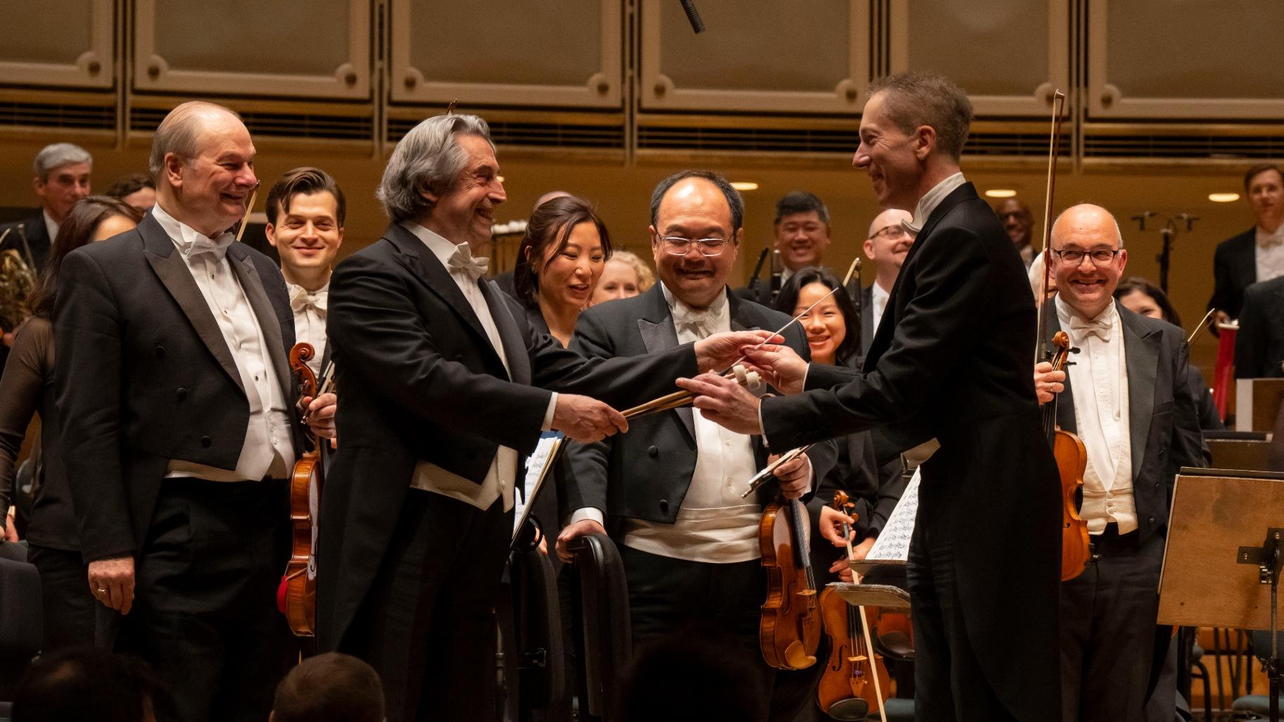 Music director Riccardo Muti and principal timpani David Herbert exchange timpani mallets and baton following Herbert’s solo debut with the CSO on Kraft’s “Timpani Concerto No. 1.” (Todd Rosenberg)