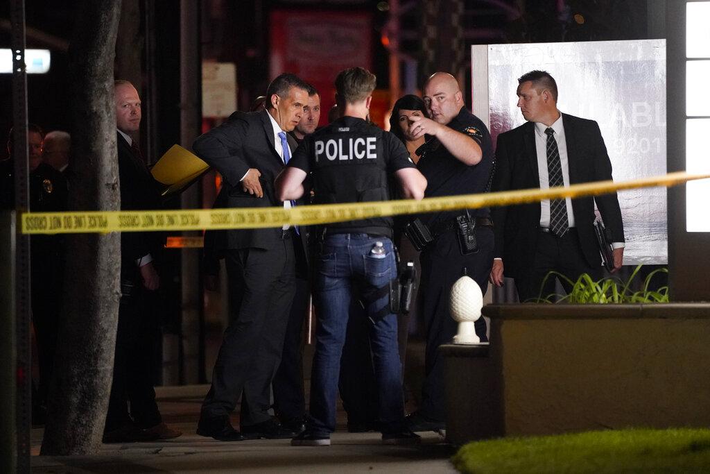 Investigators gather outside an office building where a shooting occurred in Orange, Calif., Wednesday, March 31, 2021. (AP Photo / Jae C. Hong)