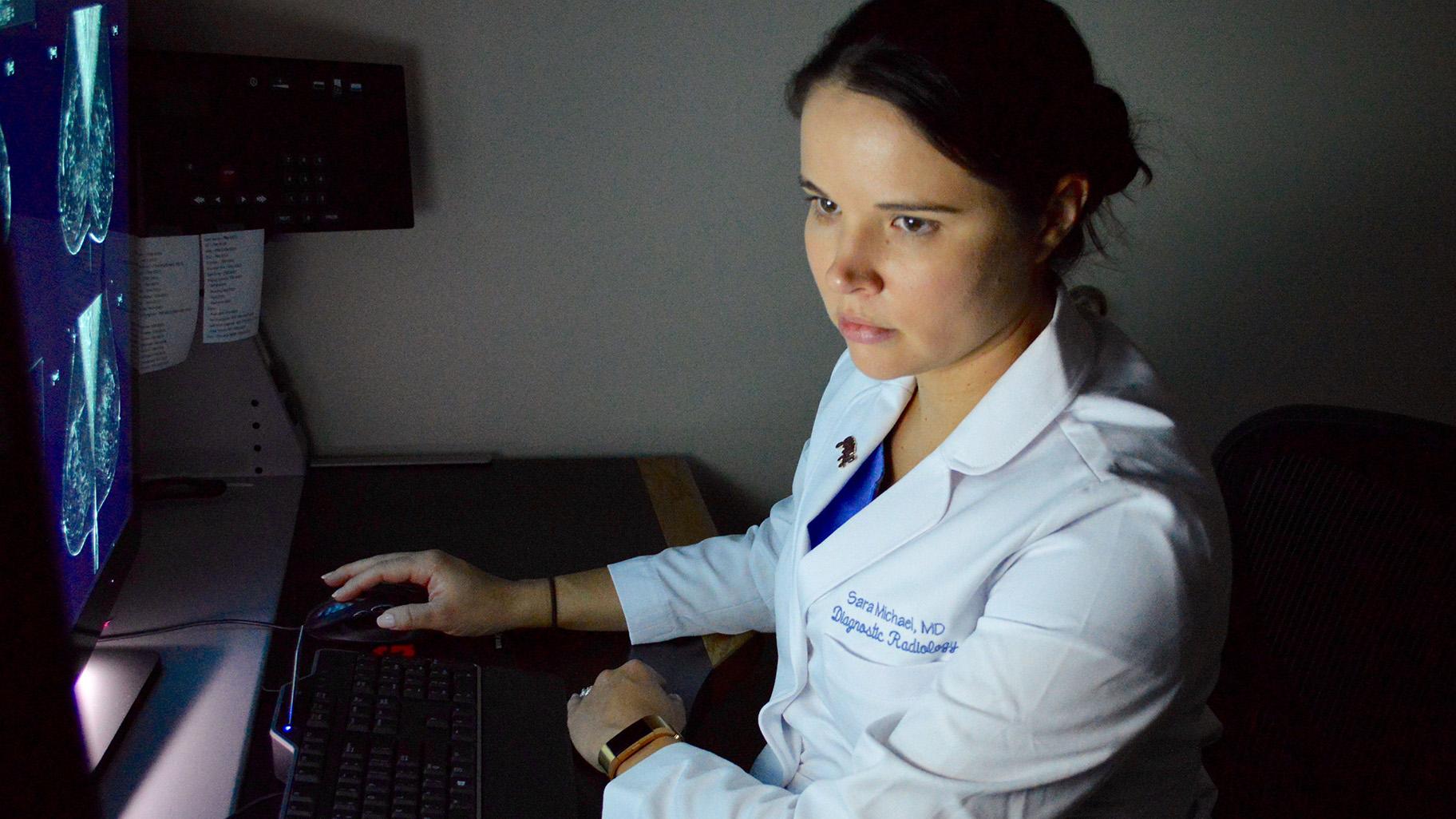 Blanchfield Army Community Hospital Chief of Mammography and Ultrasound, Maj. Sara Michael, a diagnostic radiologist, reviews a mammogram Oct. 11 to look for any abnormalities in the breast tissue that could require further testing. (Photo Credit: Maria Yager)