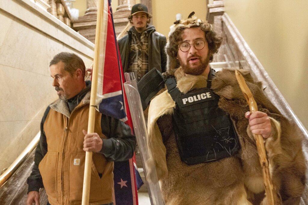 In this Jan. 6, 2021 file photo, insurrectionists loyal to President Donald Trump, including Aaron Mostofsky, right, and Kevin Seefried, left, walk down the stairs outside the Senate Chamber in the U.S. Capitol, in Washington. (AP Photo / Manuel Balce Ceneta, File)