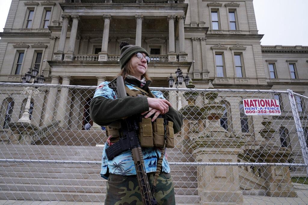 Timothy Teagan, a member of the Boogaloo Bois movement, stands with his rifle outside the state capitol in Lansing, Mich., Sunday, Jan. 17, 2021. (AP Photo / Paul Sancya)