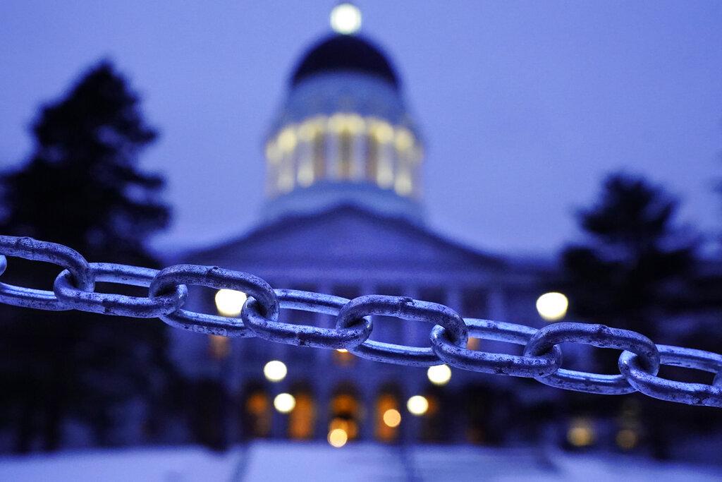 A chain blocks the sidewalk entrance to the front steps of the Maine State House, Wednesday, Jan. 13, 2021, in Augusta, Maine. (AP Photo / Robert F. Bukaty)