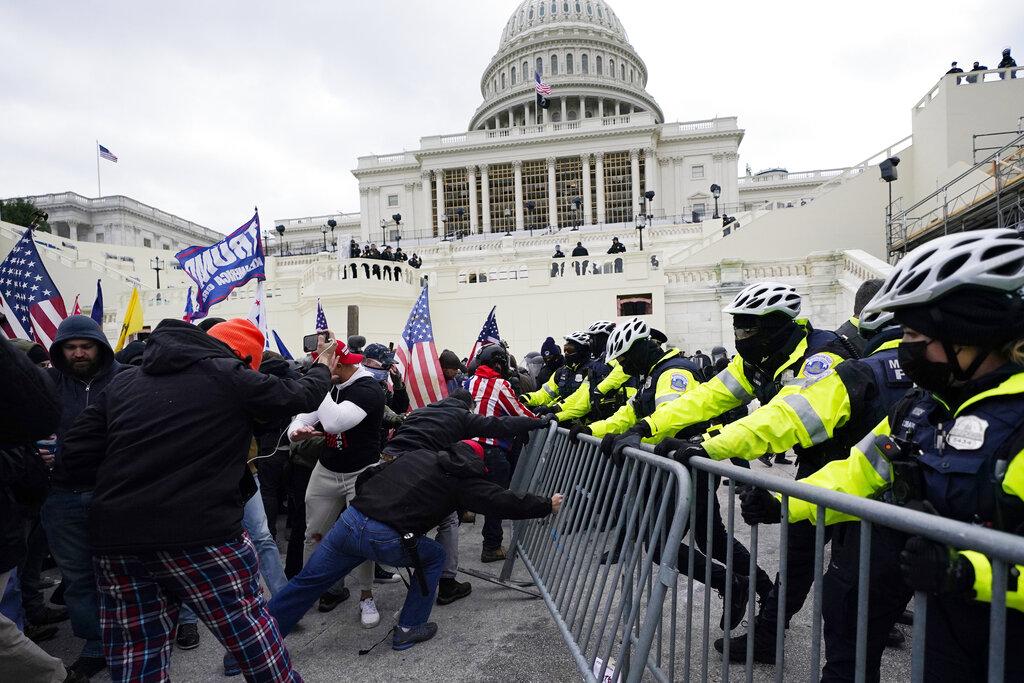 In this Wednesday, Jan. 6, 2021 file photo, Trump supporters try to break through a police barrier at the Capitol in Washington. (AP Photo / Julio Cortez, File)