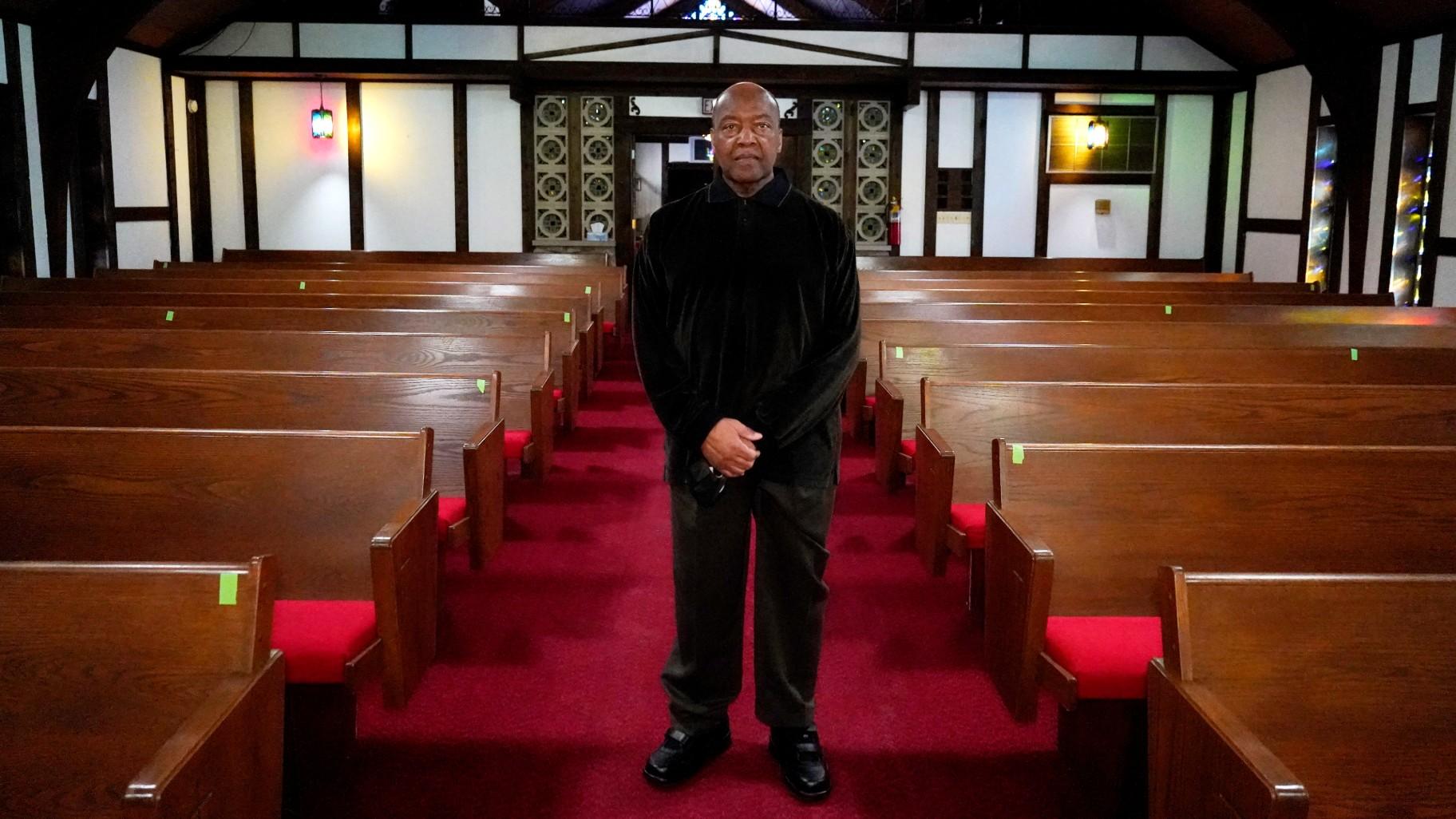 Reverend David Bigsby poses for a photo at his church in Lansing, Ill., Tuesday, Jan. 20, 2022. He moved to Lansing, Ill., 6 years ago, his predominantly black church grew during that time of at least 20%.  (AP Photo/Nam Y. Huh)