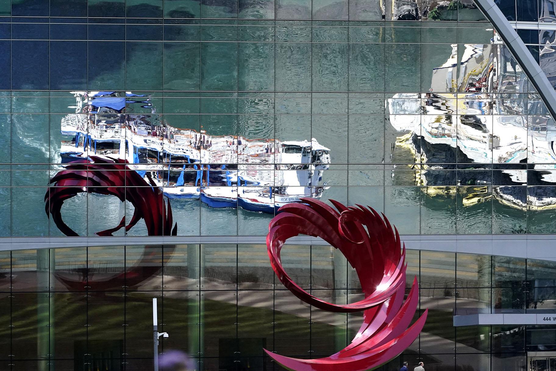 Chicago River tour boats are reflected by a building window in Chicago, Wednesday, Sept. 1, 2021. (AP Photo / Nam Y. Huh)