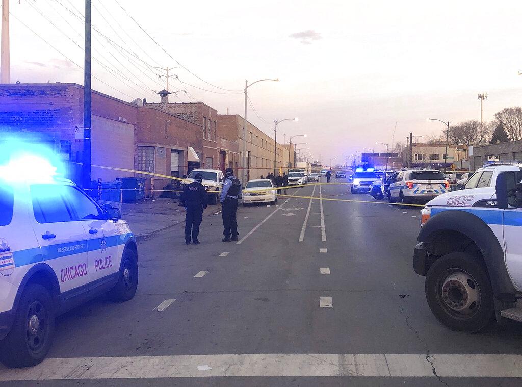 Police investigate the scene of a shooting Sunday, March 14, 2021 in the Park Manor neighborhood in Chicago. (Sophie Sherry / Chicago Sun-Times via AP)