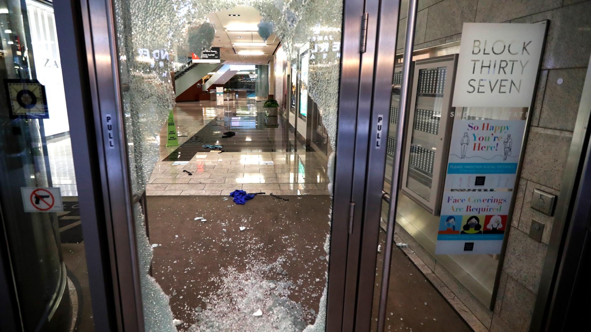 A door to the Block 37 retail building is shattered Monday, Aug. 10, 2020, after vandals struck overnight in Chicago’s famed Loop. (AP Photo / Charles Rex Arbogast)