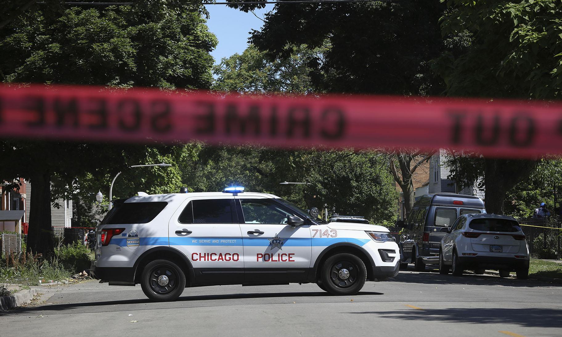 Police tape marks off a Chicago street as officers investigate the scene of a fatal shooting in the city's South Side on Tuesday, June 15, 2021. An argument in a house erupted into gunfire early Tuesday, police said. (AP Photo / Teresa Crawford)