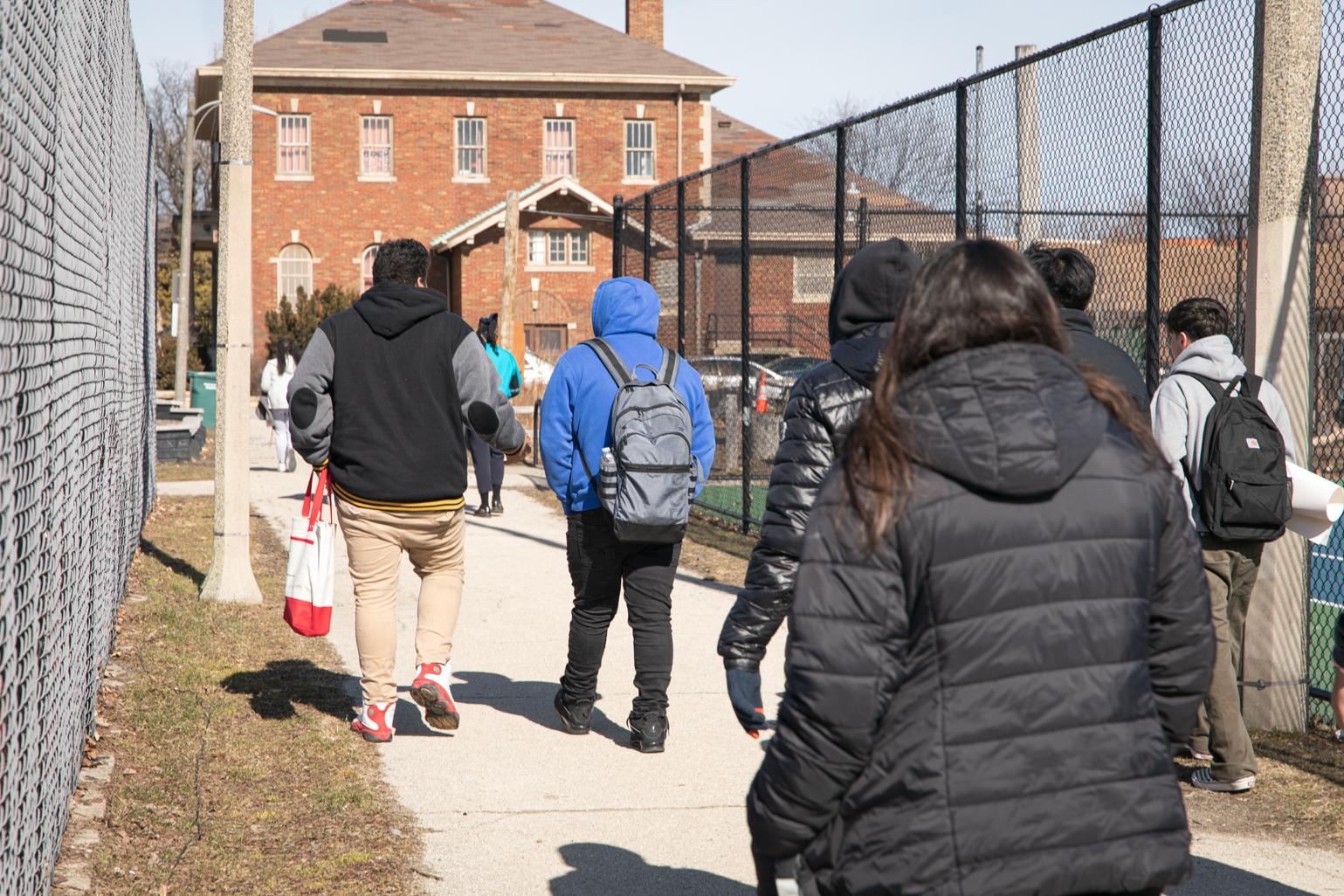 A group of Kelvyn Park High School seniors arrive at an early polling location at Kilbourn Park to register to vote and cast their ballot as part of Chicago Votes’ “Parade to the Polls” initiative on Feb. 21, 2023. (Michael Izquierdo / WTTW News)