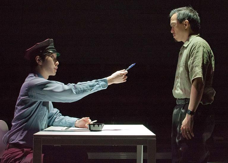 Security Guard (Dan Lin) and Zhang Lin (Norman Yap) in TimeLine Theatre’s production of Lucy Kirkwood’s “Chimerica.” (Courtesy of TimeLine Theatre)