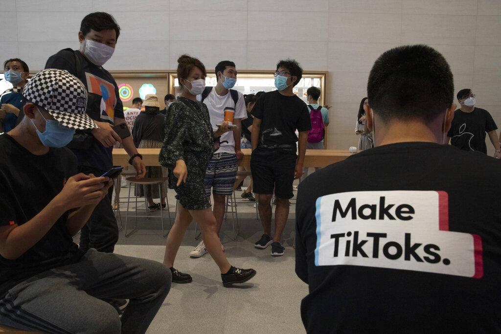 A visitor to an Apple store wears a T-shirt promoting TikTok in Beijing on Friday, July 17, 2020. (AP Photo / Ng Han Guan)