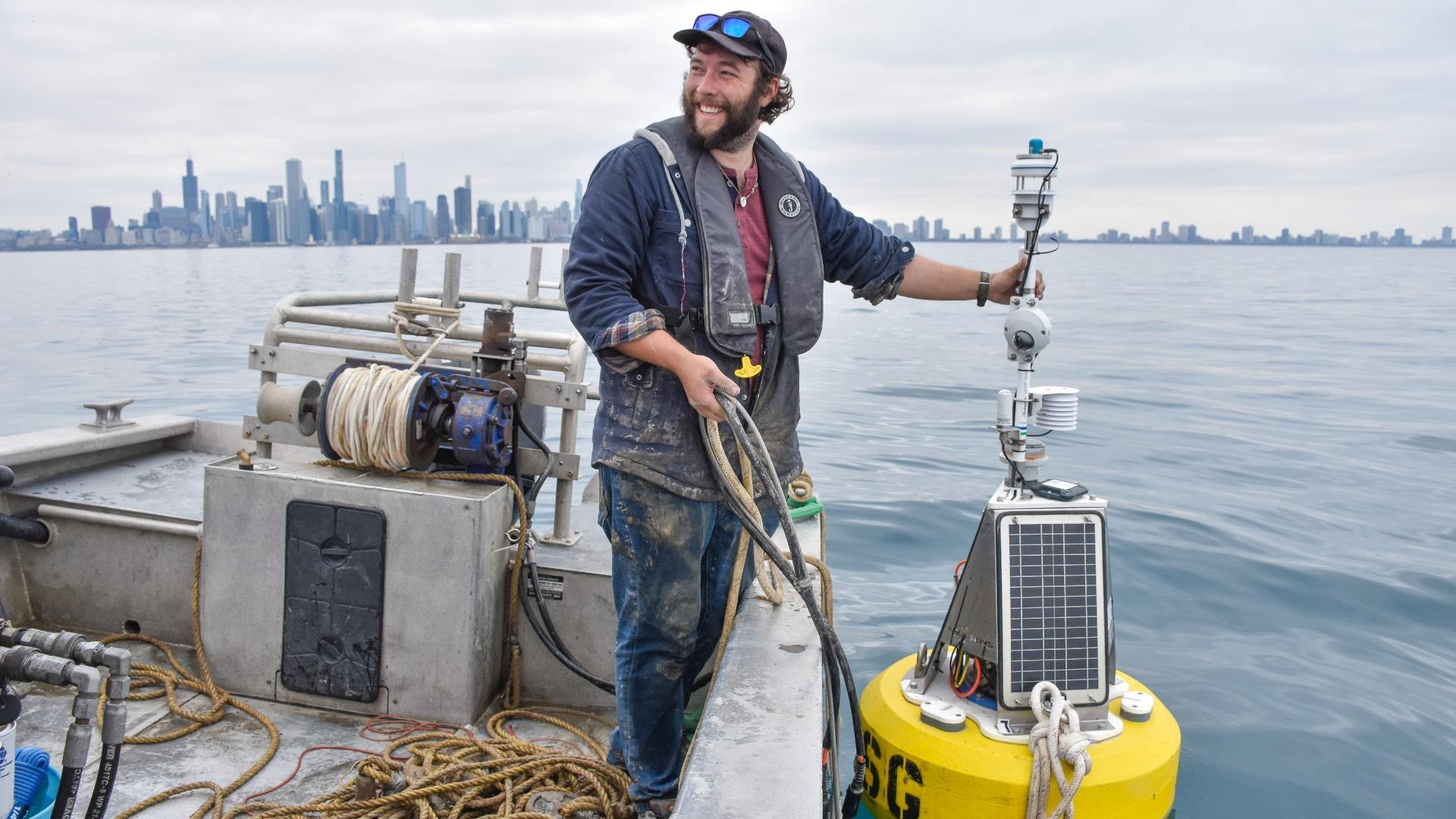 Ben Szczygiel, buoy specialist with Illinois-Indian Sea Grant, anchors Chuoy to its new post. (Illinois-Indiana Sea Grant)