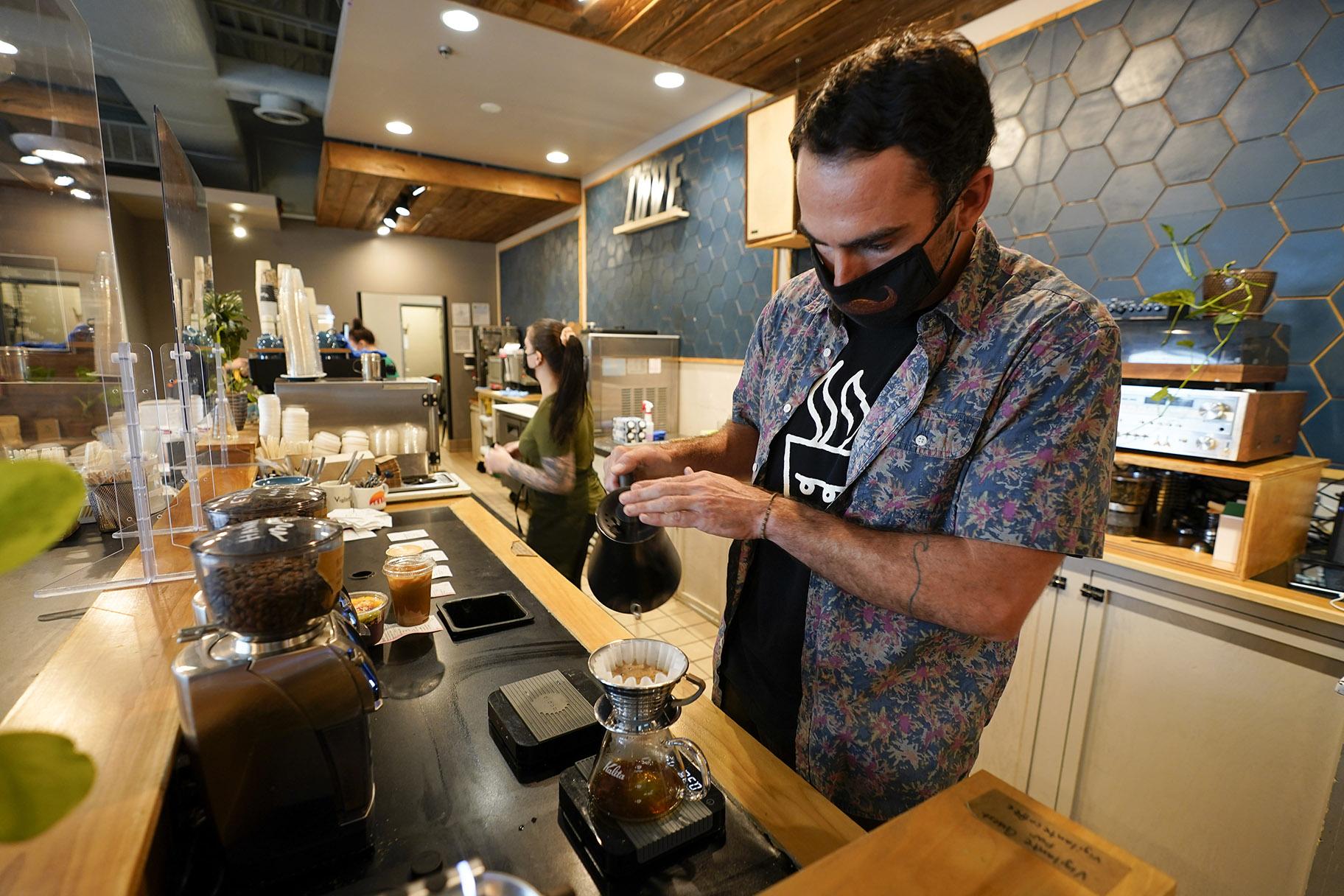 Chris Vigilante makes a dripped coffee for a customer at one of his coffee shops, Wednesday, Sept. 1, 2021, in College Park, Md. (AP Photo / Julio Cortez)