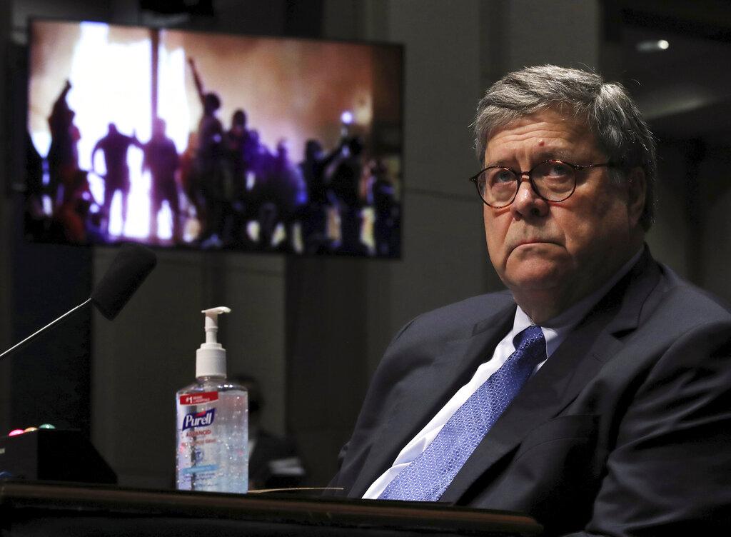 Attorney General William Barr listens during a House Judiciary Committee hearing on the oversight of the Department of Justice as a video plays in the background on Capitol Hill, Tuesday, July 28, 2020 in Washington. (Chip Somodevilla / Pool via AP)