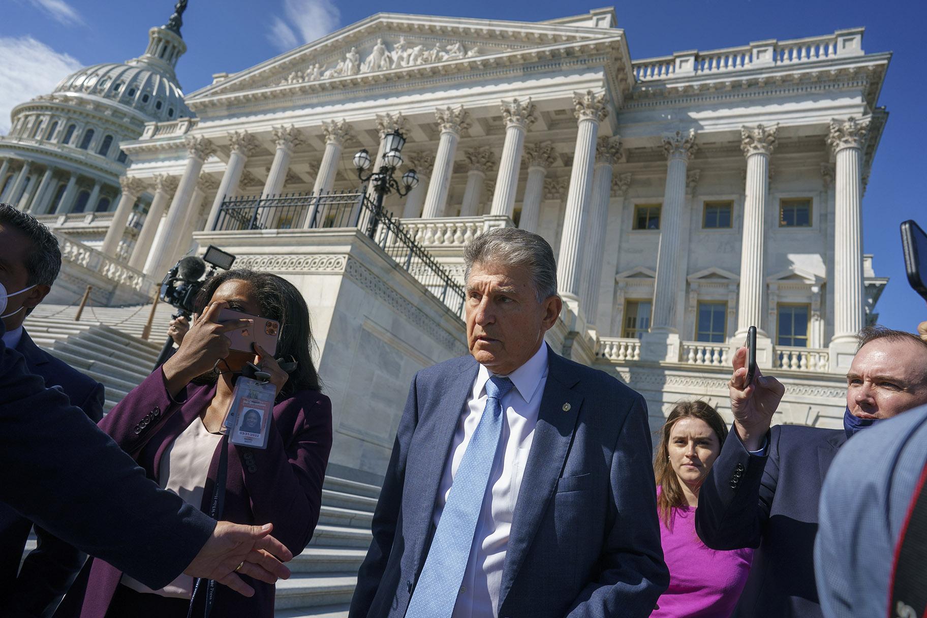 Sen. Joe Manchin, D-W.Va., a centrist Democrat vital to the fate of President Joe Biden’s $3.5 trillion domestic agenda, is surrounded by reporters outside the Capitol in Washington, Wednesday, Sept. 29, 2021. (AP Photo / J. Scott Applewhite)