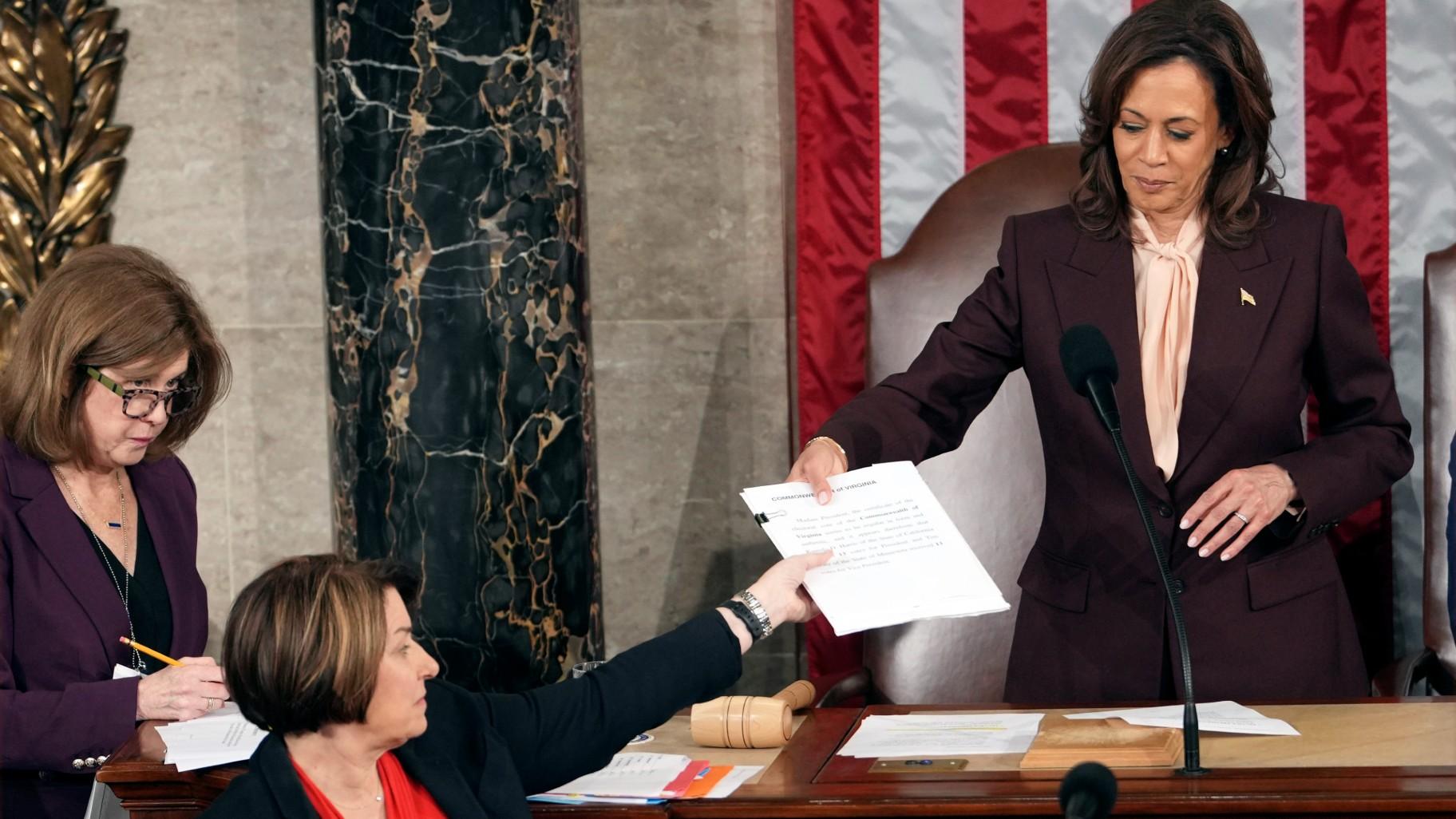 Vice President Kamala Harris hands the certification for Virginia to teller Sen. Amy Klobuchar, D-Minn., during joint session of Congress to confirm the Electoral College votes, affirming President-elect Donald Trump's victory in the presidential election, Monday, Jan. 6, 2025, at the U.S. Capitol in Washington. (AP Photo / Matt Rourke)