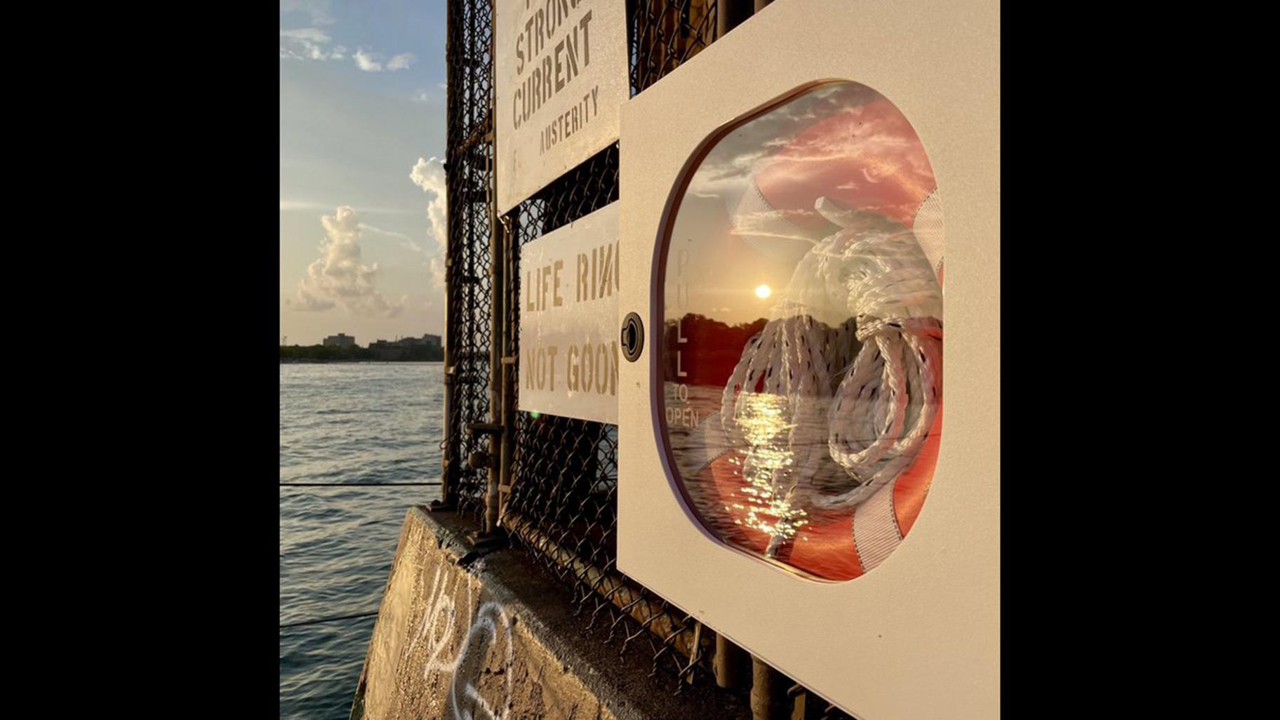 A life ring installed on the lakefront late Friday by Rogers Park activist Jim Ginderske. The photo has been edited by WTTW News to blur out a curse word that appears on an adjacent sign. (Credit Halle Quezada / Twitter)