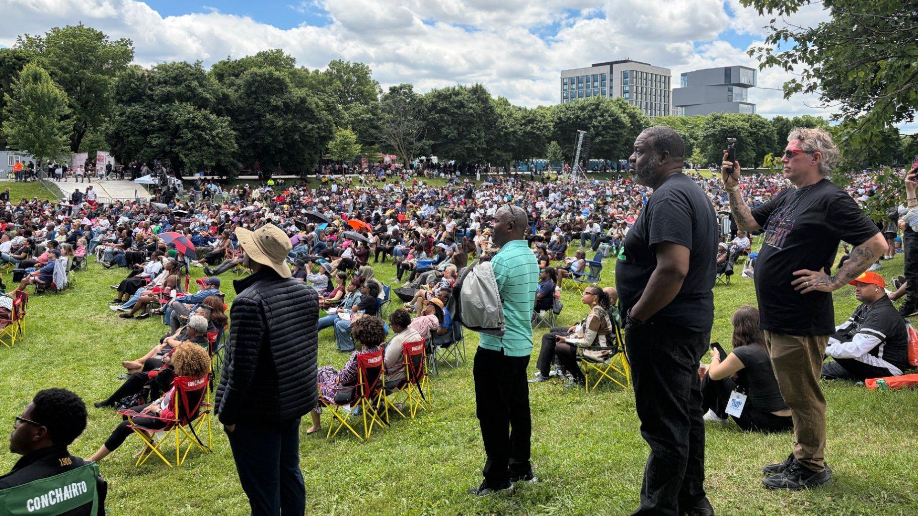The crowd watches a large screen during the Obama Presidential Center grand opening ceremony. (Eunice Alpasan / WTTW News)