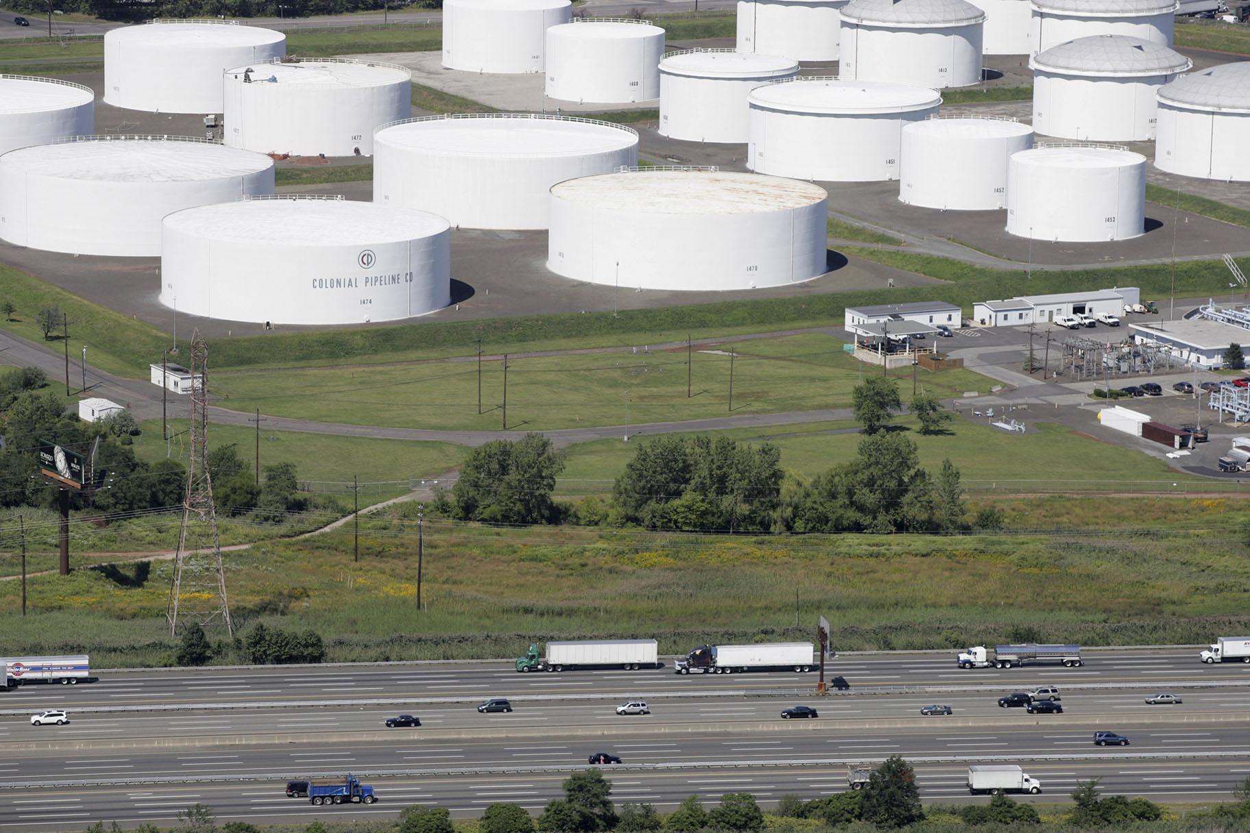 In this Sept. 8, 2008 file photo traffic on I-95 passes oil storage tanks owned by the Colonial Pipeline Company in Linden, N.J. (AP Photo / Mark Lennihan, File)