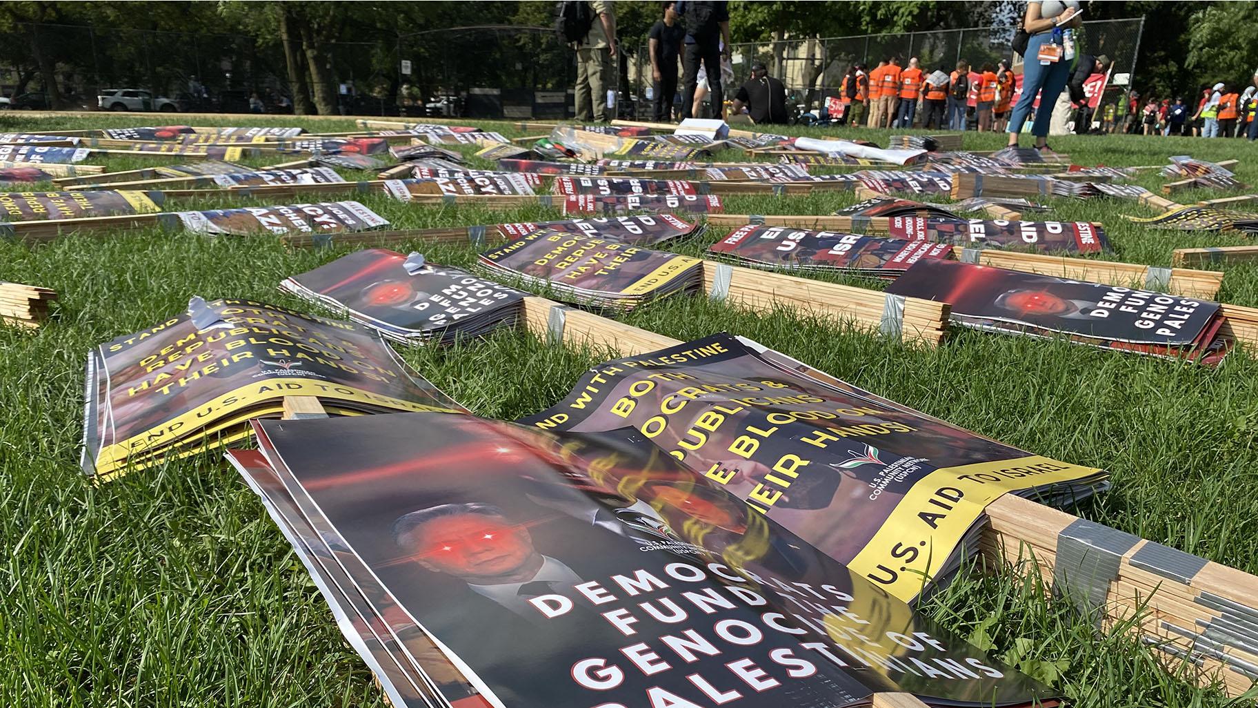 Bundles of signs are set up for protesters to carry at the Coalition to March on the DNC’s rally location in Chicago’s Union Park. (Nick Blumberg / WTTW News)